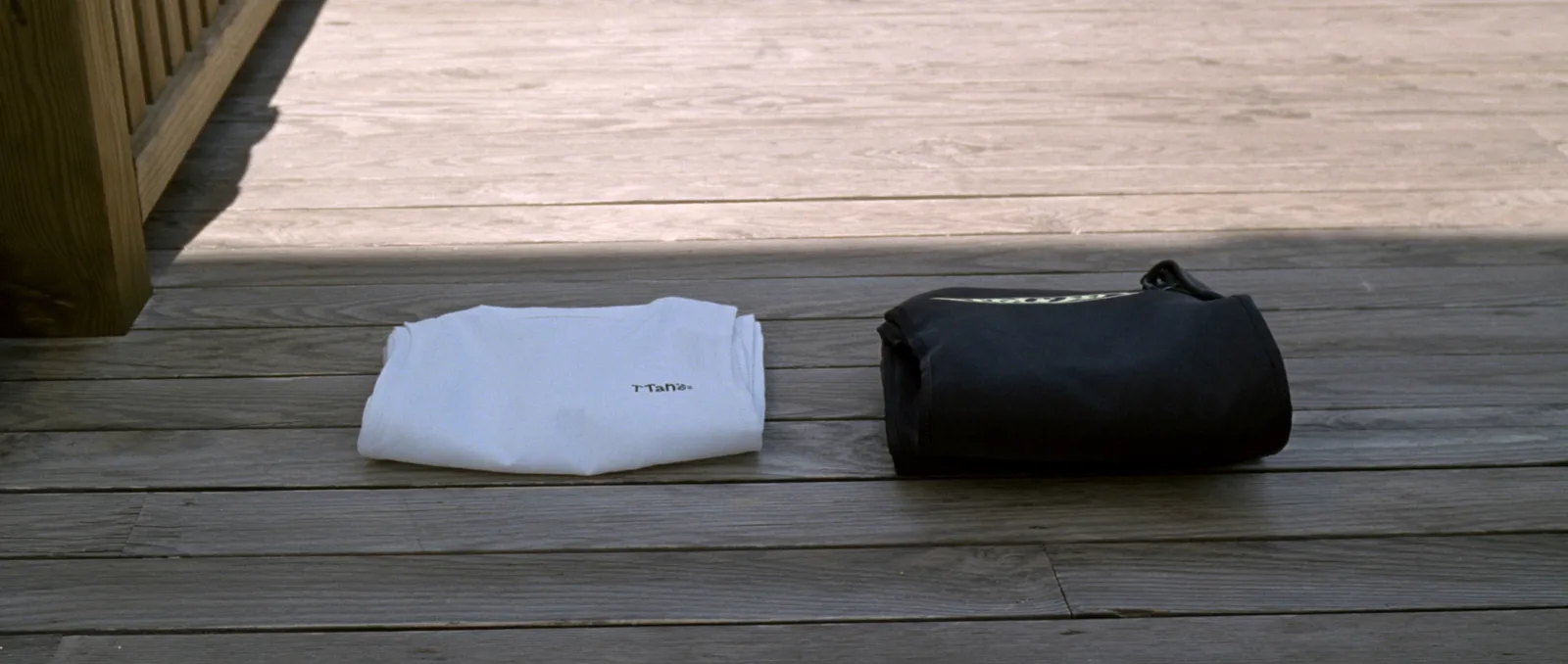 What to wear under a wetsuit — a thermal rash vest and neoprene top laid out beside a rolled wetsuit